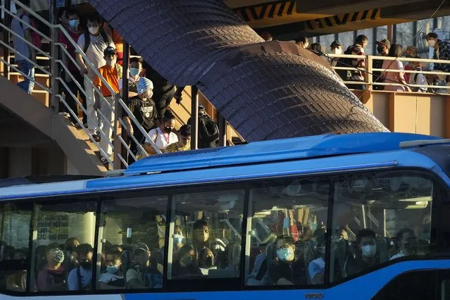 Commuters wearing face masks wait for a ride at a bus stop in metro Manila, Philippines Thursday September 8, 2022. Philippine President Ferdinand Marcos Jr. has approved a recommendation to end the mandatory wearing of face masks outdoors across the country more than two years after it was imposed at the height of the coronavirus pandemic, top officials said Wednesday. (Photo by Aaron Favila/AP Photo)
