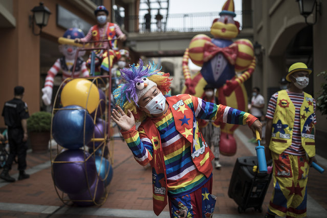 The clown is on tour at Outlets on June 7, 2020 in Wuhan,Hubei Province,China.Wuhan has seen its urban life gradually get back to normal following encouragement from local city management to open up street-stalls. Since January, China has recorded more than 81,000 cases of COVID-19 and at least 3200 deaths, mostly in and around the city of Wuhan, in central Hubei province, where the outbreak first started. (Photo by Getty Images/Stringer)