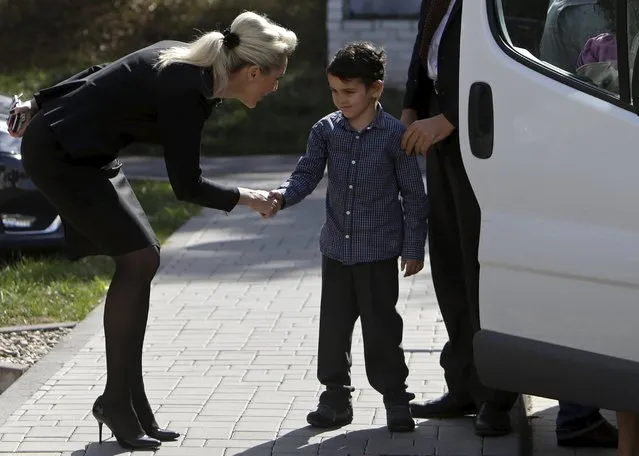 Six-year-old Ashya King (C), a British boy who received proton treatment for cancer, is welcomed as he and his family visit the Proton Therapy Center to thank medical staff in Prague, Czech Republic, September 15, 2015. Proton therapy hit the headlines in Britain last year when five-year-old King was removed from hospital by his parents, against the advice of doctors, and flown to Prague for proton treatment. The family say he is now free of cancer. (Photo by David W. Cerny/Reuters)