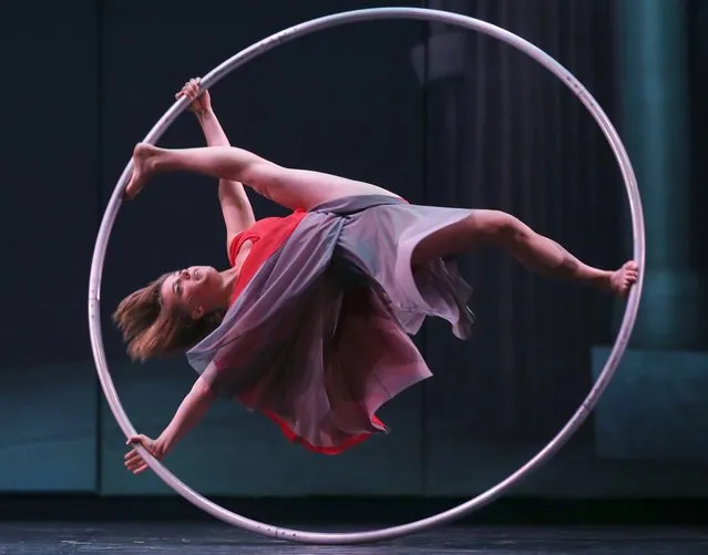 Lea Toran Jenner of the Canadian troupe Cirkopolis performs with a ring during a dress rehearsal at the Sydney Opera House in Sydney, Australia Thursday, October 2, 2014. The show combines circus, dance and theatre, featuring twelve acrobats and artists is playing at the Opera House from Oct. 2 to Oct. 6. (Photo by Rick Rycroft/AP Photo)