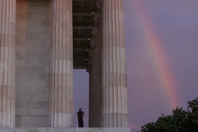 A rainbow appears behind the Lincoln Memorial as Lisa Fitzpatrick prepares to begin her day, coincidentally Juneteenth — the day celebrating Lincoln’s emancipation of African American slaves more than a century and a half ago, with a sunrise walk in Washington, U.S. June 19, 2020. (Photo by Jonathan Ernst/Reuters)