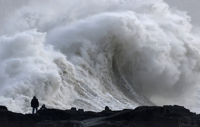 A person views large waves as Storm Eowyn arrives, in Porthcawl, Wales, Britain, on January 24, 2025. (Photo by Toby Melville/Reuters)
