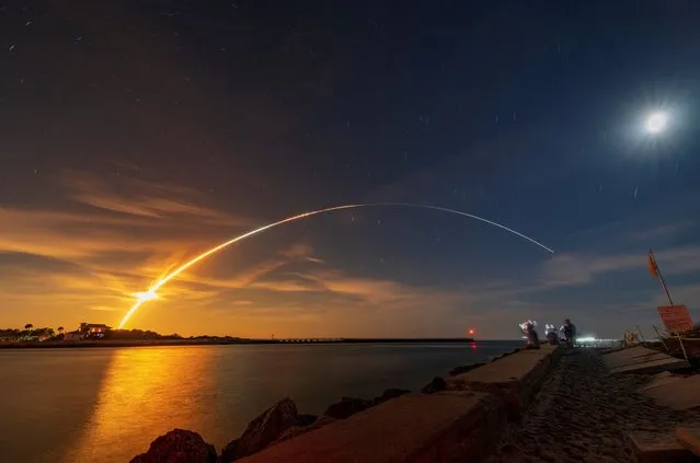 NASA's next-generation moon rocket, the Space Launch System (SLS) rocket with the Orion crew capsule, lifts off from launch complex 39-B on the unmanned Artemis 1 mission to the moon, seen from Sebastian, Florida, U.S. November 16, 2022. (Photo by Joe Rimkus Jr./Reuters)