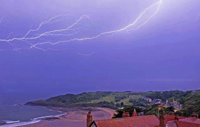 Fork lightening rains down over Langland Bay near Swansea, Wales in the early hours of this morning on May 21, 2020. (Photo by Phil Rees/Rex Features/Shutterstock)