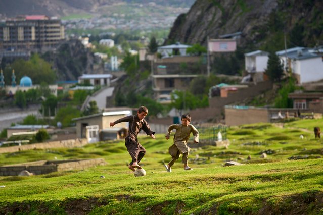 Afghan boys play football at a hilltop in Faizabad district, Badakhshan province on April 10, 2025. (Photo by Omer Abrar/AFP Photo)