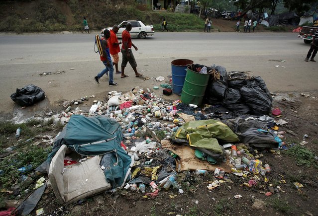 African migrants stranded in Costa Rica walk near garbage on the Inter-American highway in the border between Costa Rica and Nicaragua, in Penas Blancas, Costa Rica, September 7, 2016. (Photo by Juan Carlos Ulate/Reuters)