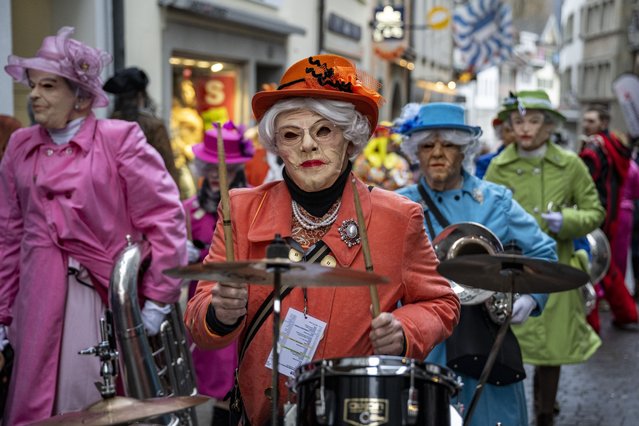 Masked Guggen music bands (brass and percussion carnival bands) attend the “Urknall” (Big Bang), which occurs at Kapellplatz at five in the morning and marks the start of the Lucerne carnival (Fasnacht) on Fat Thursday in Lucerne, Switzerland, 08 February 2024. The carnival in Lucerne takes place from February 8 until February 13. (Photo by Urs Flueeler/EPA/EFE)