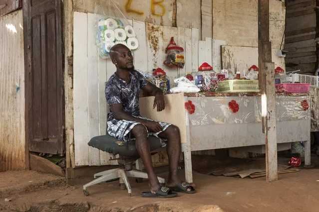 A man waits for customers in his shop in the slum district of Mont Baduel, in Cayenne, French Guiana, Friday, July 10, 2020. France's most worrisome virus hotspot is in fact on the border with Brazil - in French Guiana, a former colony where health care is scarce and poverty is rampant. The pandemic is exposing deep economic and racial inequality in French Guiana that residents say the mainland has long chosen to ignore. (Photo by Pierre Olivier Jay/AP Photo)