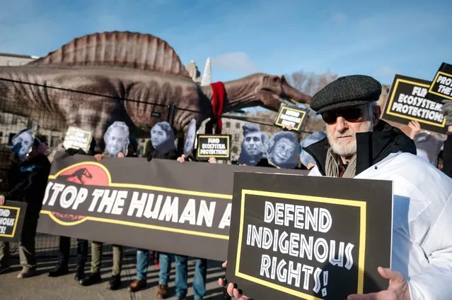 Actor James Cromwell (R) and protesters hold up signs in the Old Port of Montreal during the United the Nations Biodiversity Conference (COP15) in Montreal, Quebec, Canada, on December 15, 2022. (Photo by Andrej Ivanov/AFP Photo)