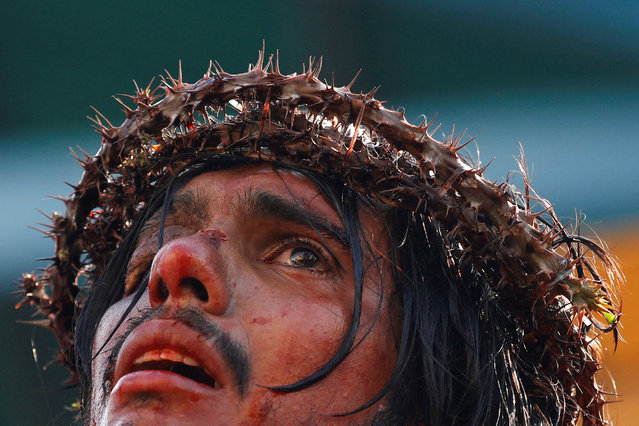 An amateur actor portraying Jesus Christ performs during the reenactment of the crucifixion of Jesus Christ during the Good Friday procession in the neighbourhood of Petare, in Caracas, Venezuela on April 18, 2025. (Photo by Leonardo Fernandez Viloria/Reuters)