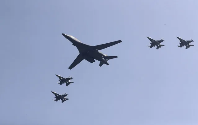 U.S. B-1 bomber, center, flies over Osan Air Base with U.S. jets in Pyeongtaek, South Korea, Tuesday, September 13, 2016. The United States has flown nuclear-capable supersonic bombers over ally South Korea in a show of force meant to cow North Korea after its fifth nuclear test and also to settle rattled nerves in the South. (Photo by Lee Jin-man/AP Photo)