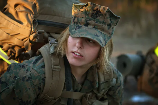 Pfc. Schevlle Woodard from Grand Prairie, Texas prepares to head out on a 15-kilometer night march with male and female Marines during Marine Combat Training (MCT) on February 21, 2013 at Camp Lejeune, North Carolina.  Since 1988 all non-infantry enlisted male Marines have been required to complete 29 days of basic combat skills training at MCT after graduating from boot camp. MCT has been required for all enlisted female Marines since 1997. About six percent of enlisted Marines are female.  (Photo by Scott Olson)