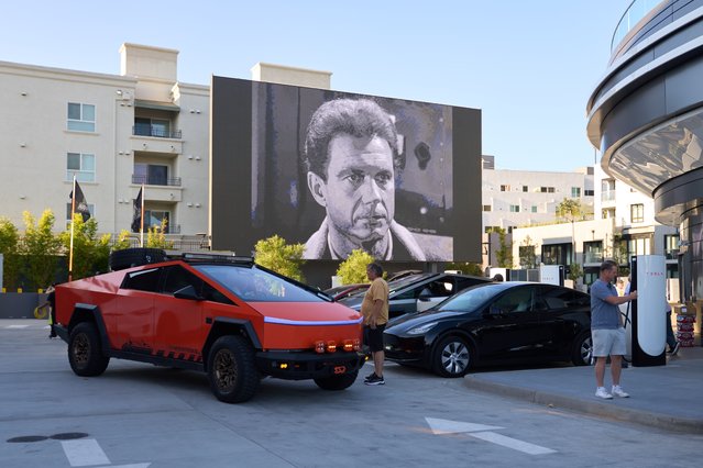 A large screen plays a movie as cars charge at the Tesla Diner in Los Angeles, CA, USA, 22 July 2025. Tesla's second-quarter earnings report will be released on 23 July 2025. )Photo by Allison Dinner/EPA)
