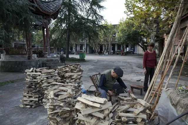 Pneumoconiosis patients and their relatives prepare wood for cooking at Yangjia Hospital in Wuyi County, Zhejiang Province, China October 19, 2015. (Photo by Damir Sagolj/Reuters)