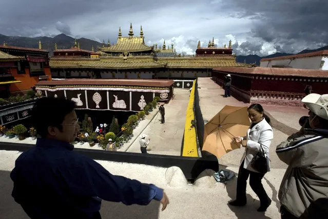 In this July 27, 2007, file photo, tourists visit the Jokhang Monastery, one of the oldest Tibetan monasteries in Lhasa in China's Tibet Autonomous Region. Chinese authorities say they've ruled out arson as the cause of a fire on Saturday, February 17, 2018, that damaged a 1,300-year-old monastery that is one of Tibetan Buddhism's most sacred sites. (Photo by Ng Han Guan/AP Photo)