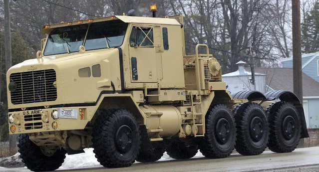 A view motorists have grown accustomed seeing, a military truck made by Oshkosh Corp. is taken for a test drive Thursday, April 11, 2013 in Oshkosh, Wis. Faced with deep cuts in U.S. military spending, and the end of the wars in Iraq and Afghanistan, Oshkosh Corp. is laying off 900 employees in its defense division based in Oshkosh. Approximately 700 hourly workers at the state's largest manufacturer will lose their jobs in mid-June, followed by approximately 200 salaried employees through July. (Photo by Mark Hoffman via The Journal Sentinel)