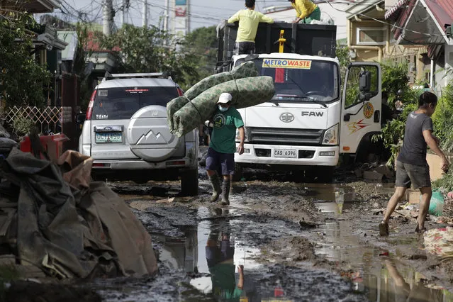 A man salvages a bed as he walks along a mud-covered road after floodwaters caused by Typhoon Goni rose inside their village in Batangas city, Batangas province, south of Manila, Philippines on Monday, November 2, 2020. Super typhoon Goni left wide destruction as it slammed into the eastern Philippines with ferocious winds early Sunday and about a million people have been evacuated in its projected path. (Photo by Aaron Favila/AP Photo)
