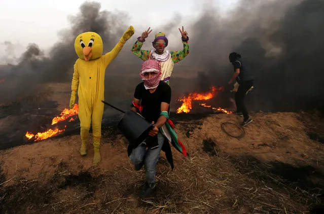 Palestinians wearing costumes are seen at the clashes scene at Israel-Gaza border in the southern Gaza Strip April 5, 2018. (Photo by Ibraheem Abu Mustafa/Reuters)
