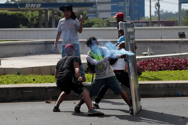 A demonstrator fires a homemade mortar towards riot police during a protest over a controversial reform to the pension plans of the Nicaraguan Social Security Institute (INSS) in Managua, Nicaragua April 20, 2018. (Photo by Oswaldo Rivas/Reuters)