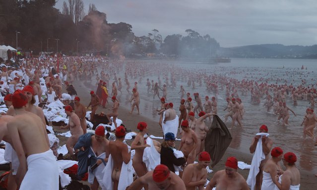 Swimmers participate in the annual nude winter solstice swim during Hobart's Dark Mofo festival at Long Beach in Hobart, Australia, 21 June 2024. (Photo by Ethan James/AAP)