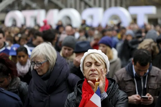 Lena Polyvyannaya of Toronto closes her eyes during a moment of silence in memory of the victims of the Paris attacks, outside city hall in Toronto, November 14, 2015. (Photo by Chris Helgren/Reuters)