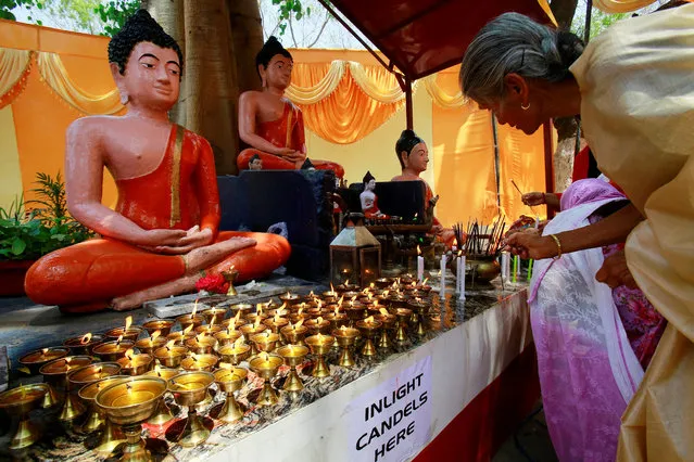 Devotees light candles at a Buddhist temple on the occasion of Buddha Purnima festival, also known as Vesak Day, in Chandigarh, India, April 30, 2018. (Photo by Ajay Verma/Reuters)