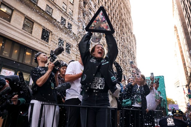 New York Liberty guard Sabrina Ionescu holds up the WNBA basketball championship trophy while riding down Broadway during a parade celebrating the team's season championship, Thursday, October 24, 2024, in New York. (Photo by Yuki Iwamura/AP Photo)