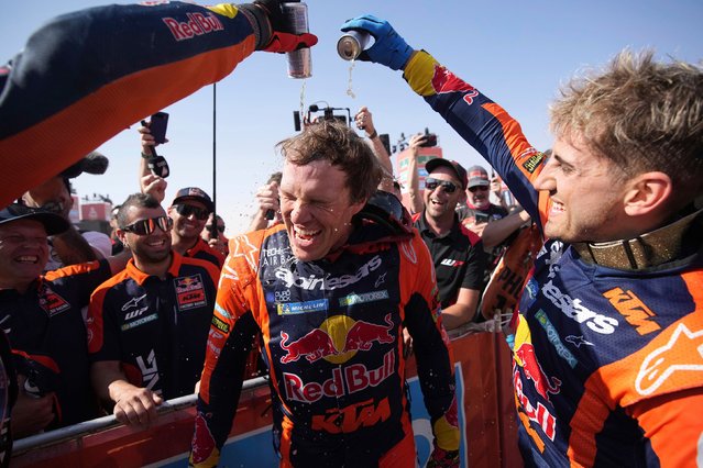 Motorcycle rider Daniel Sanders of Australia celebrates winning the Dakar Rally after the twelfth stage in Shubaytah, Saudi Arabia, Friday, January 17, 2025. (Photo by Christophe Ena/AP Photo)