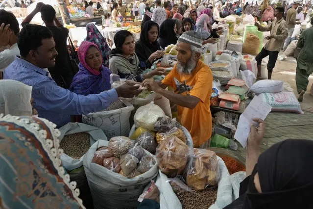 People buy grocery items at a bazaar, setup by provincial government to provide items on discounted rates, in Karachi, Pakistan, Wednesday, April 12, 2023. The International Monetary Fund has slashed the growth outlook for cash-strapped Pakistan, forecasting the South Asian country's fragile economy will grow just 0.5% this year, down from 6% in 2022. (Photo by Fareed Khan/AP Photo)