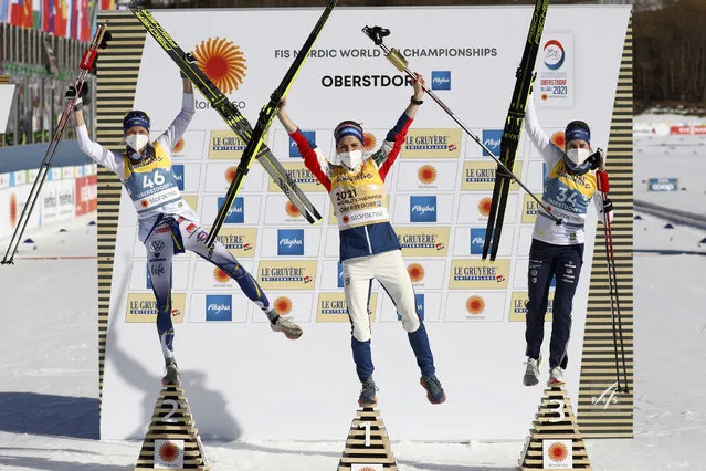 Winner Therese Johaug of Norway, center, celebrates flanked by second placed Frida Karlsson of Sweden, left, and third placed Ebba Andersson of Sweden after the 10km women's interval start free race at the FIS Nordic World Ski Championships in Oberstdorf, Germany, Tuesday, March 2, 2021. (Photo by Matthias Schrader/AP Photo)