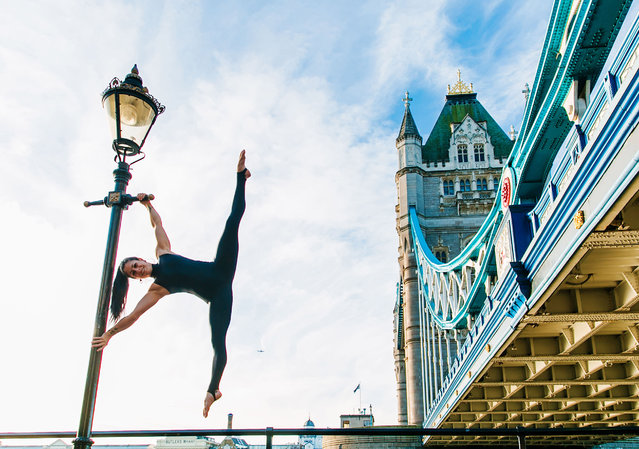 Yoga in front of the Tower Bridge, London. (Photo by Kristina Kashtanova/Caters News)