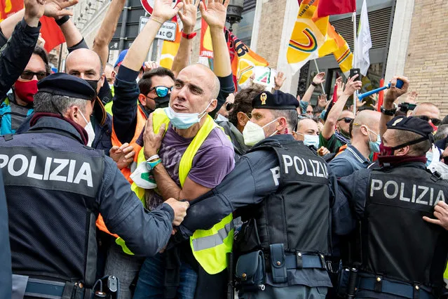 Police and protesters scuffle during a demonstration against plans to revamp Alitalia, in Rome, Italy, 21 April 2021. The Italian government is in negotiations with EU authorities to overhaul the flag carrier Alitalia to a state-owned airline ITA. (Photo by Massimo Percossi/EPA/EFE)