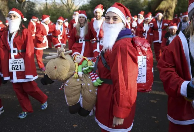Participants take part in a Santa Run at Battersea Park in London, Britain December 3, 2016. (Photo by Neil Hall/Reuters)