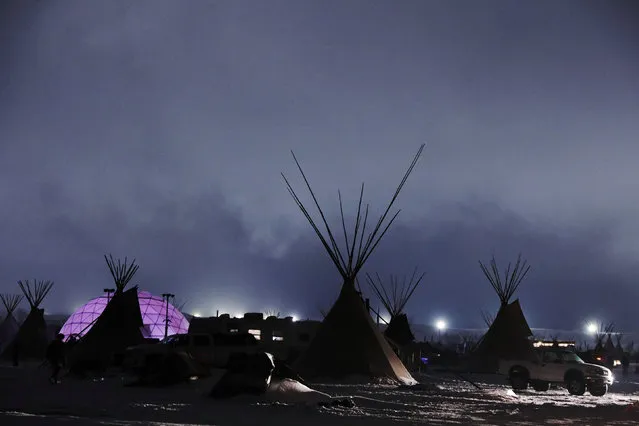 Tipis stand in the night inside of the Oceti Sakowin camp as demonstrations against plans to pass the Dakota Access pipeline continue near the Standing Rock Indian Reservation, near Cannon Ball, North Dakota, U.S., December 1, 2016. (Photo by Lucas Jackson/Reuters)
