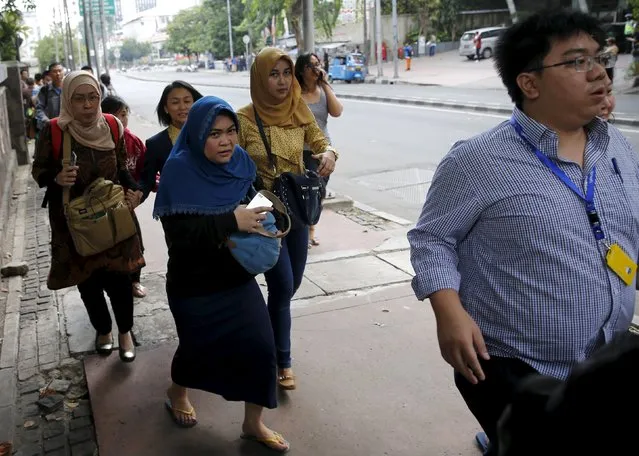Indonesian workers run as they are evacuated from their office at Thamrin business district in Jakarta January 14, 2016. Several explosions went off and gunfire broke out in the center of the Indonesian capital on Thursday and police said they suspected a suicide bomber was responsible for at least one the blasts. (Photo by Reuters/Beawiharta)