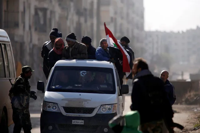 People ride a pick-up truck with a Syrian National flag in goverment controlled Hanono housing district in Aleppo, Syria December 4, 2016. (Photo by Omar Sanadiki/Reuters)