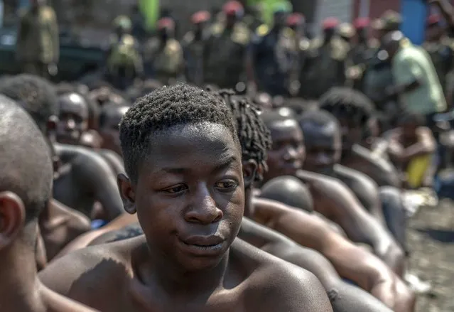 Arrested members of the Wazalendo sect are sat and lined up in Goma, Democratic Republic of the Congo, Wednesday, August 30, 2023. More than 40 people died and dozens were injured in clashes in the Congolese city of Goma between protesters from the Wazalendo religious sect and the armed forces, national authorities said. (Photo by Moses Sawasawa/AP Photo)