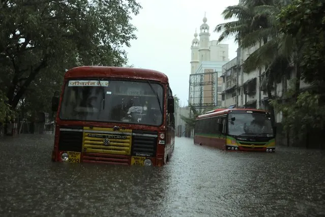 Passenger buses are stranded on a waterlogged road after heavy rains caused by Cyclone Tauktae in Mumbai, India, May 17, 2021. (Photo by Francis Mascarenhas/Reuters)