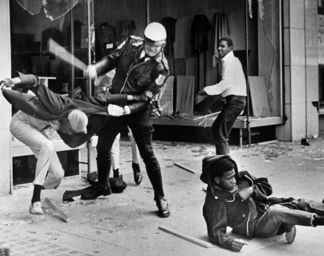 A police officer uses his nightstick on a youth reportedly involved in the looting that followed the breakup of a march led by Dr. Martin Luther King Jr. March 28, 1968, in Memphis, Tenn. Black leaders accused the police of brutality while police officers said they did what was necessary to restore order. In the wake of the violence, a curfew was imposed and more than 3,800 National Guardsmen were rushed to the city. A week later, King was assassinated at Memphis' Lorraine Motel. (Photo by Jack Thornell/AP Photo)