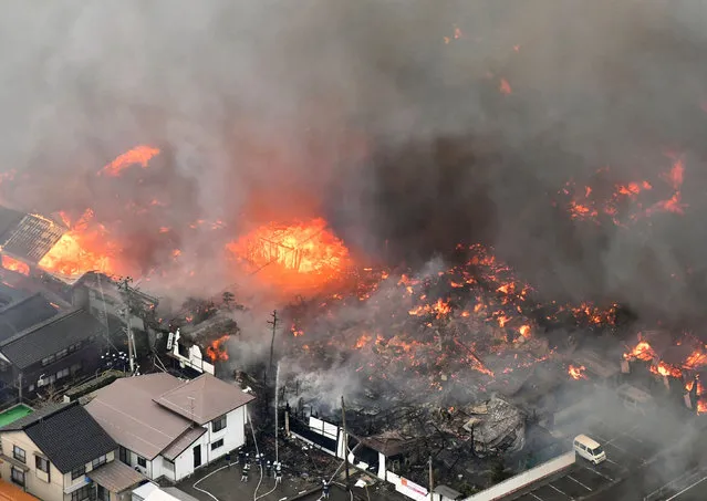 Smoke billow from houses during a fire in Itoigawa, northern Japan, Thursday, December 22, 2016.  A fire whipped by high winds has spread to at least 140 buildings in a small Japanese city on the Japan Sea coast. The fire department said the blaze started at a restaurant in Itoigawa city Thursday morning. By mid-afternoon, 140 houses and other buildings had caught fire, and the fire is still spreading. (Photo by Kyodo News via AP Photo)