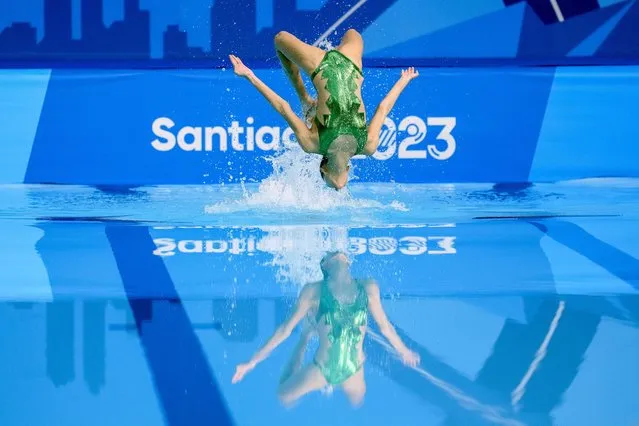 Cuba's Dayaris Varona and Gabriela Alpajon compete in the artistic swimming duets free routine final at the Pan American Games in Santiago, Chile, Thursday, November 2, 2023. (Photo by Esteban Felix/AP Photo)