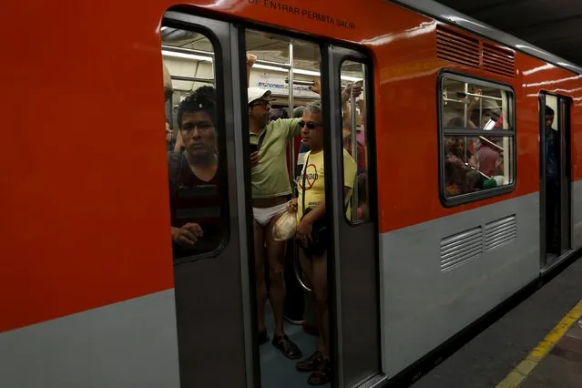 Passengers not wearing pants stand is a subway train during the “No Pants Subway Ride” in Mexico City, Mexico, February 21, 2016. (Photo by Carlos Jasso/Reuters)