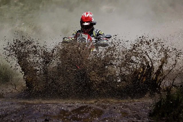 Yamaha rider Juan Carlos Carignani of Italy rides his quad through a creek during the first stage of the Dakar Rally between the cities of Rosario and San Luis in San Luis, Argentina, on January 5, 2014. (Photo by Victor R. Caivano/Associated Press)