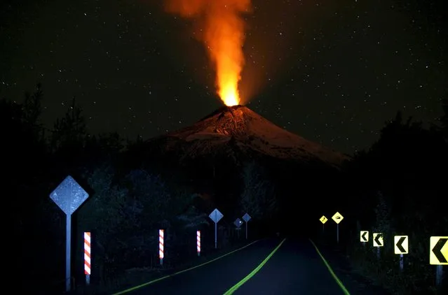 Smoke and lava spew from the Villarrica volcano, as seen from Pucon town, in the south of Santiago, April 22, 2015. Authorities have restricted access to the area within 5 kilometres (3 miles) of the crater and have put the area under an orange alert due to the volcano's heightened unrest and increased likelihood of eruption. (Photo by Cristobal Saavedra/Reuters)