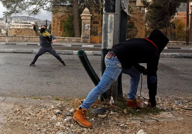 A Palestinian protester uses a sling to hurl stones towards Israeli troops during clashes in the West Bank city of Bethlehem January 26, 2017. (Photo by Mussa Qawasma/Reuters)