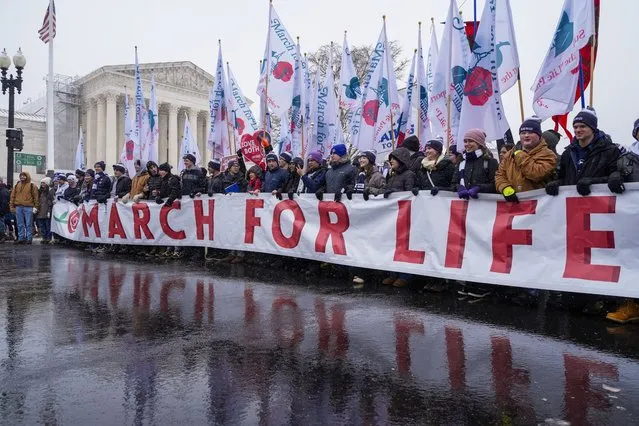 People participating in the March for Life walk past the Supreme Court, Friday, January 19, 2024, in Washington. (Photo by Jacquelyn Martin/AP Photo)
