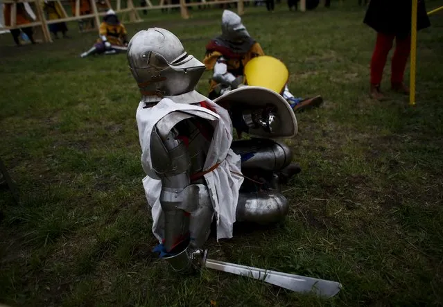 A Fighter from the Japanese team and his German opponent sit on the ground during their fight during the Medieval Combat World Championship at Malbork Castle, northern Poland, April 30, 2015. (Photo by Kacper Pempel/Reuters)