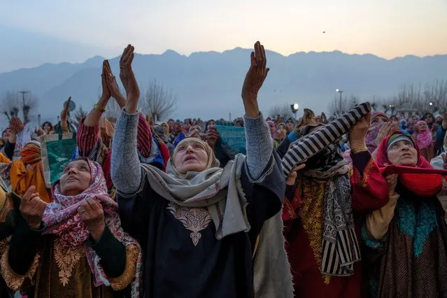 Kashmiri Muslims raise their hands for prayers outside the Hazratbal Shrine in Srinagar, Indian controlled Kashmir, Friday, February 16, 2024, as the head priest, unseen, displays a holy relic believed to be a hair from the beard of Prophet Mohammad, following the Islamic festival of Shab-e-Meraj that took place at the shrine last Thursday. Shab-e-Meraj, the anniversary of Prophet Mohammad's ascent to heaven, was marked on February 8. (Photo by Dar Yasin/AP Photo)