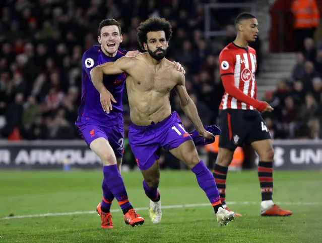 Liverpool's Mohamed Salah, center, celebrates with Andrew Robertson after scoring his side's second goal during the English Premier League soccer match between Southampton and Liverpool at St Mary's stadium in Southampton, England Friday, April 5, 2019. (Photo by Kirsty Wigglesworth/AP Photo)