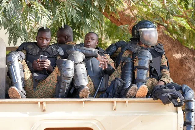 Burkina Faso Police sit outside the courtroom where 14 people, including former President Blaise Compaore, stand trial as charged with the murder of leader Thomas Sankara, in Ougadougou, Burkina Faso, Monday, October 11, 2021. A military court in Burkina Faso has started the trial of 14 people including former President Compaore for the killing of influential leftist leader Thomas Sankara, who was ousted as president by Compaore in a 1987 coup. (Photo by Sam Mednick/AP Photo)